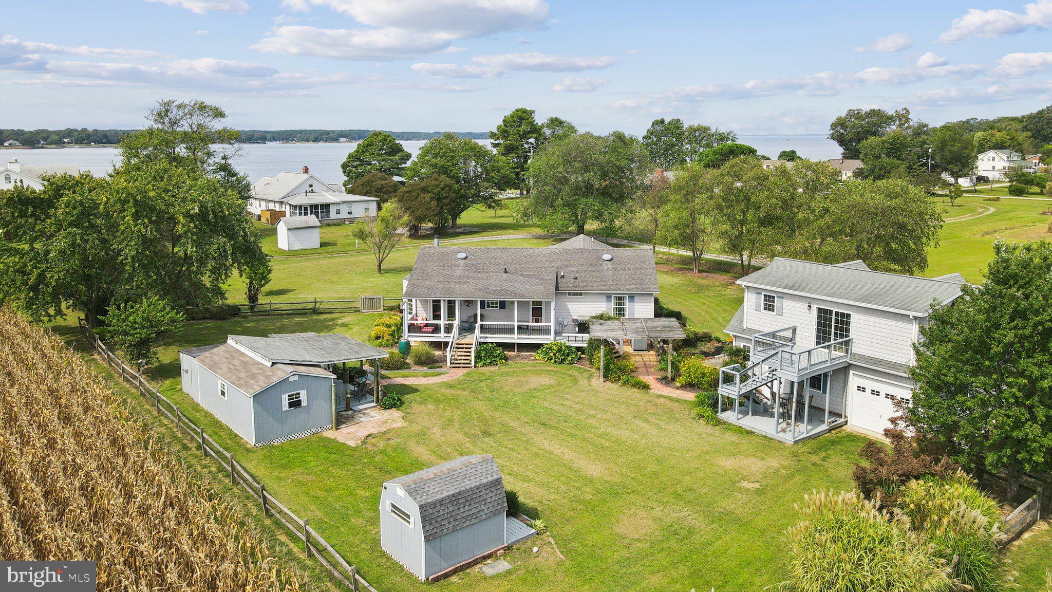 an aerial view of a house with swimming pool and green space