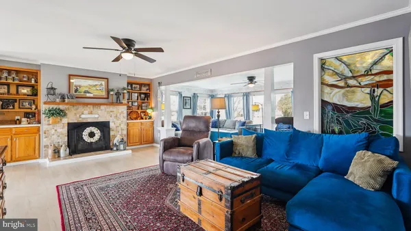 a living room with hard wood floors and a fireplace