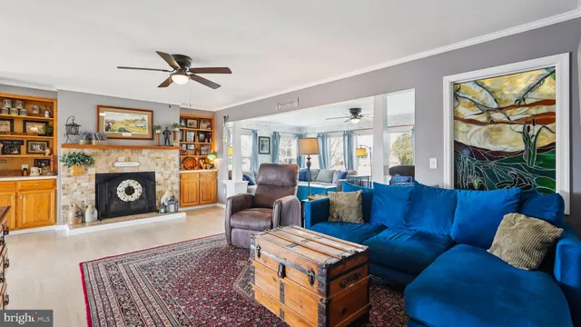 a living room with hard wood floors and a fireplace