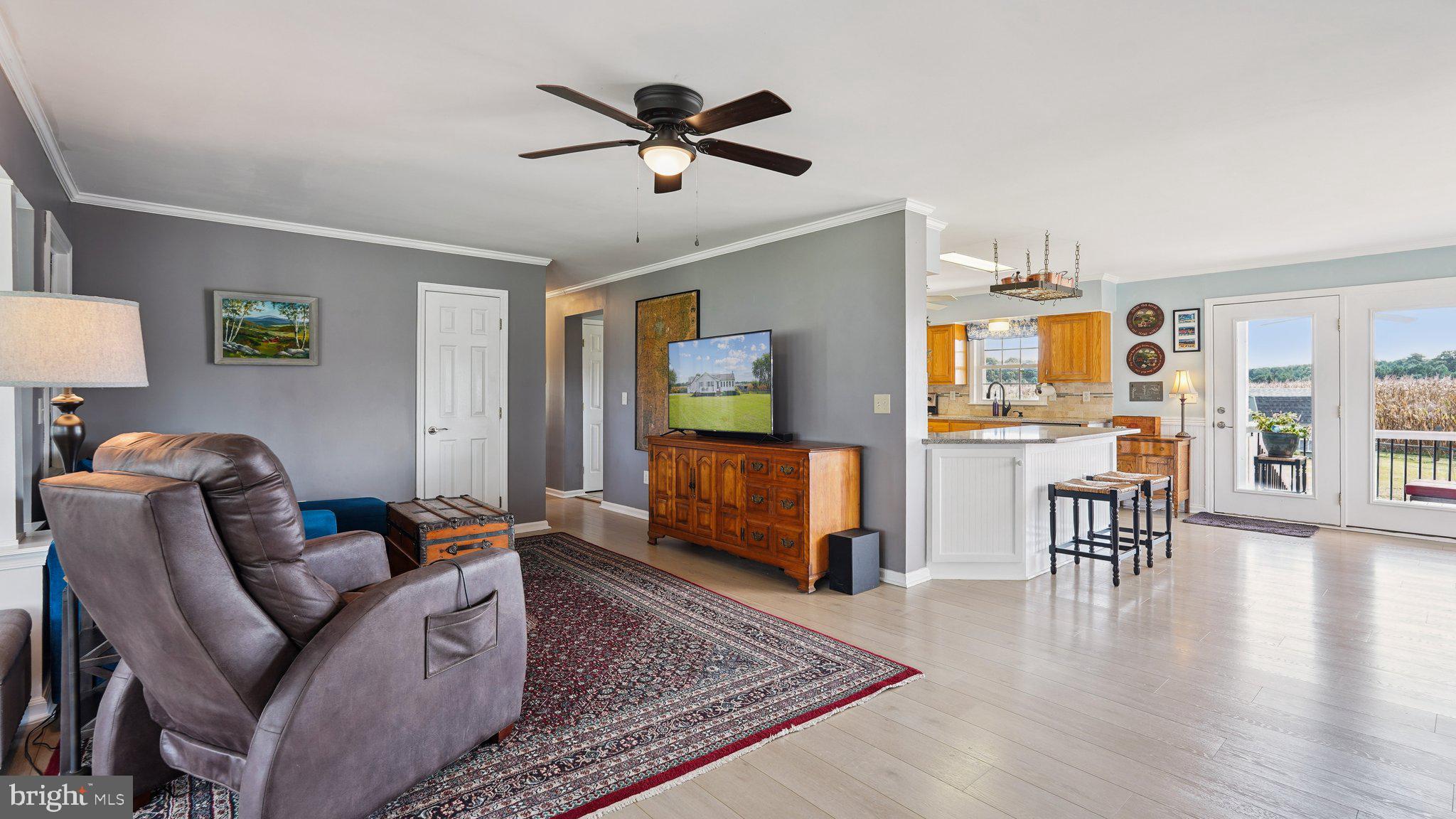 4387 Coles Point Road Hague, VA 22469 - Photo 13 of 39 a living room with furniture wooden floor and a flat screen tv