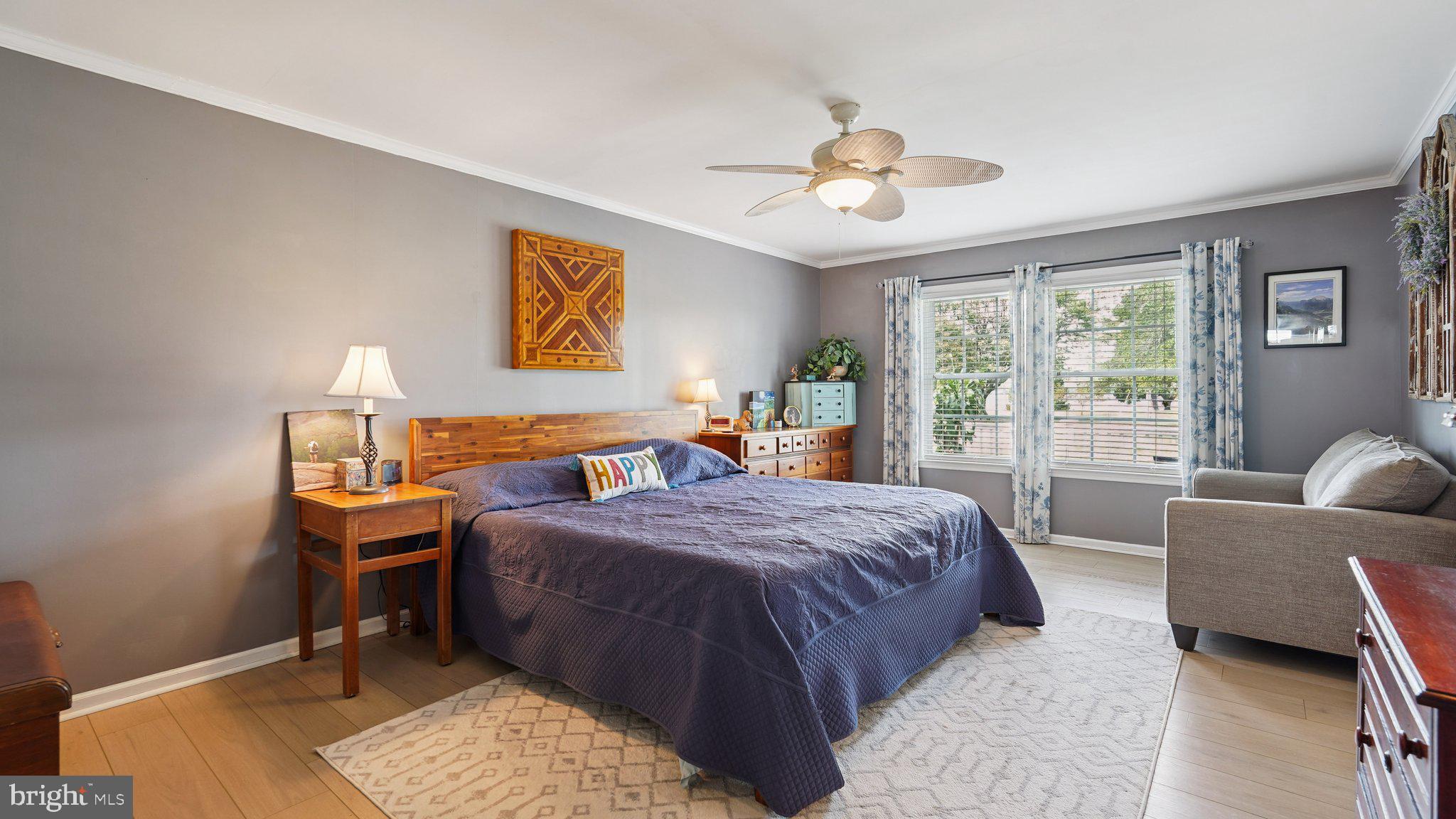 4387 Coles Point Road Hague, VA 22469 - Photo 16 of 39 a bedroom with a bed and wooden floor