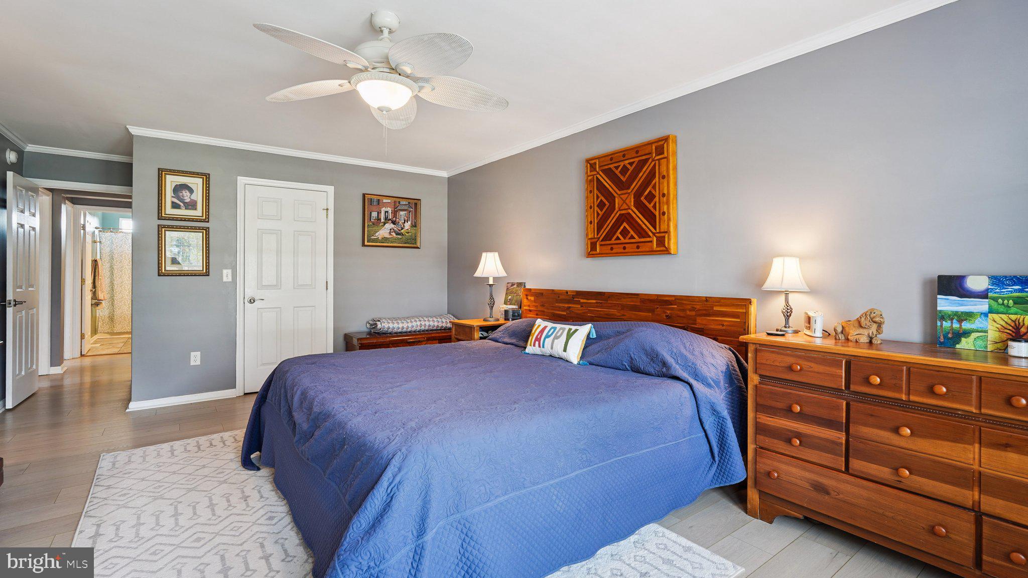 4387 Coles Point Road Hague, VA 22469 - Photo 17 of 39 a bedroom with a bed and a chandelier