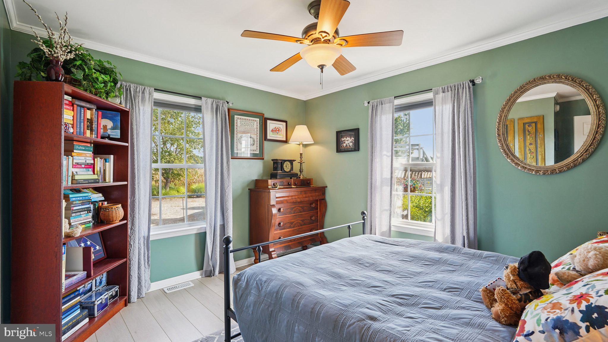 4387 Coles Point Road Hague, VA 22469 - Photo 22 of 39 a bedroom with a bed and a bookshelf