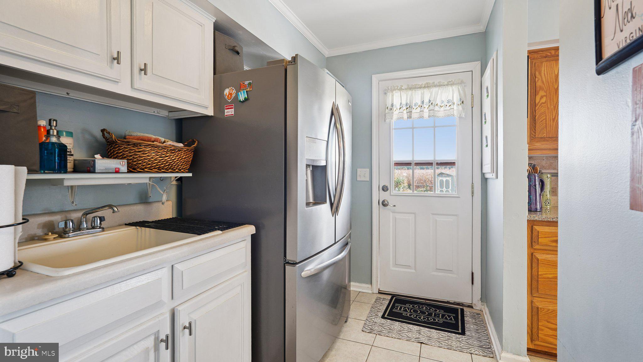 4387 Coles Point Road Hague, VA 22469 - Photo 25 of 39 a kitchen with a refrigerator and cabinets
