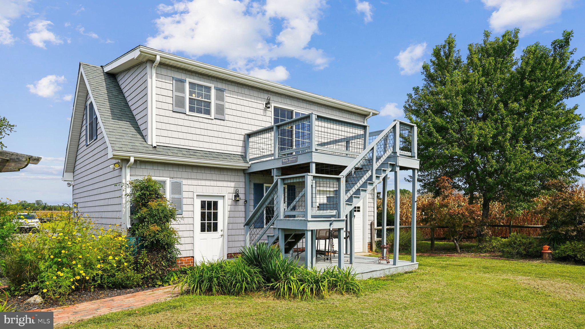 4387 Coles Point Road Hague, VA 22469 - Photo 26 of 39 a front view of a house with a garden