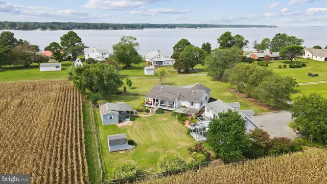 an aerial view of a house with a garden and lake view