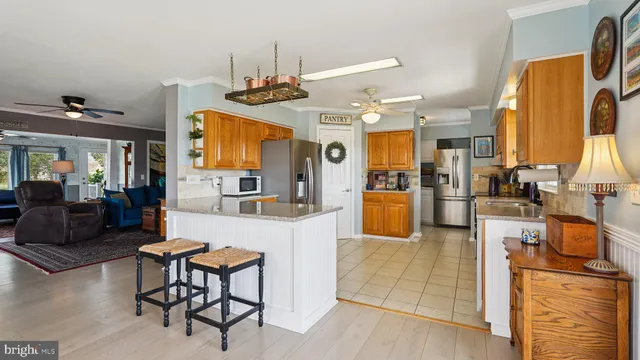 a kitchen with stainless steel appliances granite countertop a refrigerator and a stove