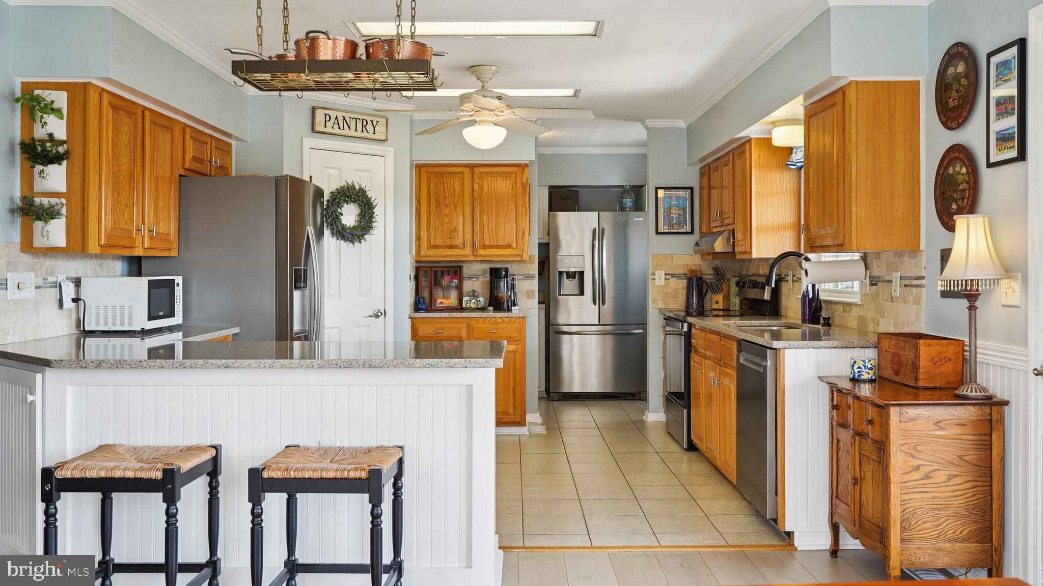 4387 Coles Point Road Hague, VA 22469 - Photo 8 of 39 a kitchen with stainless steel appliances granite countertop a refrigerator and a stove