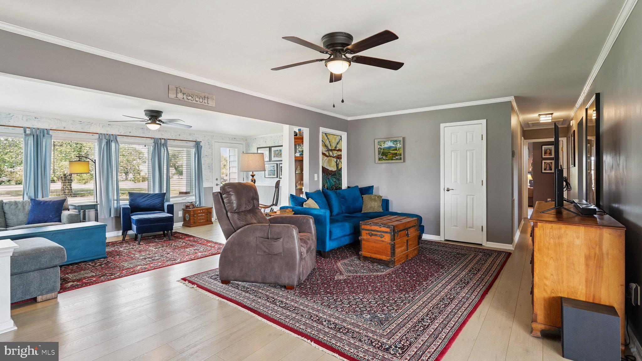 4387 Coles Point Road Hague, VA 22469 - Photo 10 of 39 a living room with furniture a rug and a chandelier