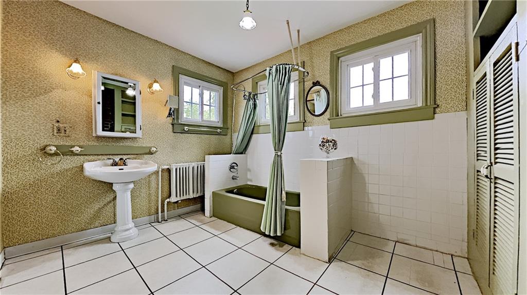 8150 Peebles Road Pittsburgh, PA 15237 - Photo 17 of 25 a bathroom with a sink a mirror and a shower