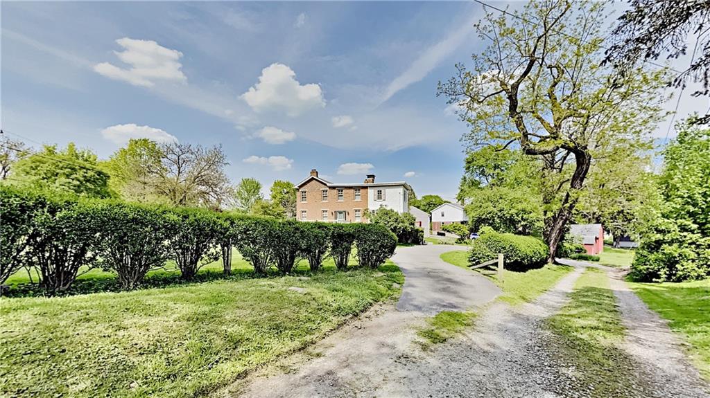 8150 Peebles Road Pittsburgh, PA 15237 - Photo 22 of 25 a front view of a house with a yard and fountain in middle