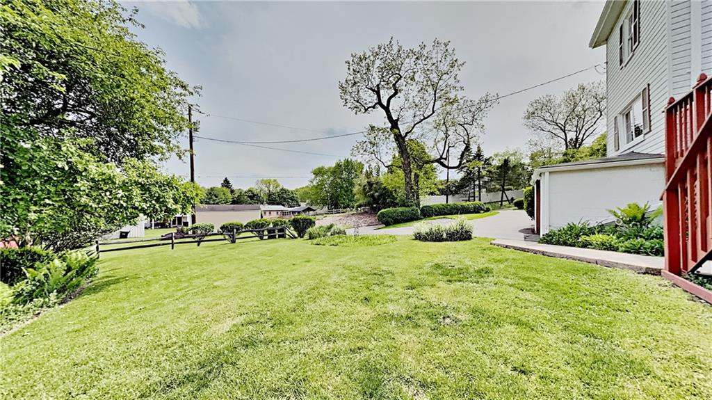 8150 Peebles Road Pittsburgh, PA 15237 - Photo 24 of 25 a backyard of a house with table and chairs plants and large tree