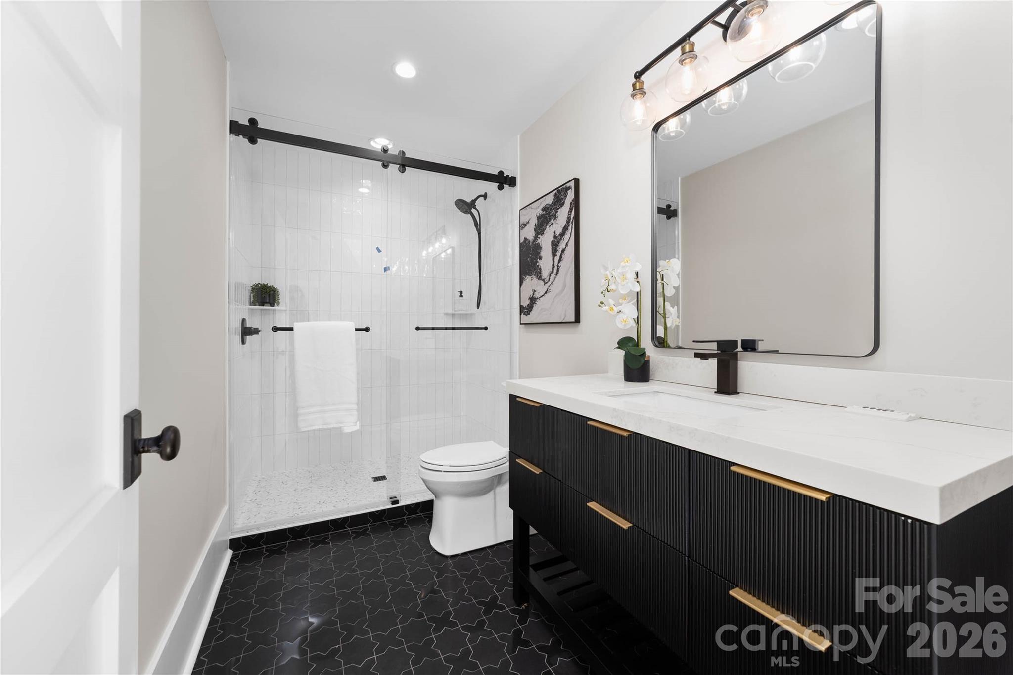 216 Walnut Street Davidson, NC 28036 - Photo 40 of 48 a bathroom with a granite countertop sink toilet and shower