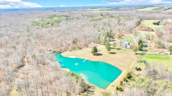 a view of a big yard with large trees