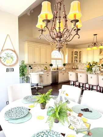 a view of a dining room with furniture a chandelier and wooden floor