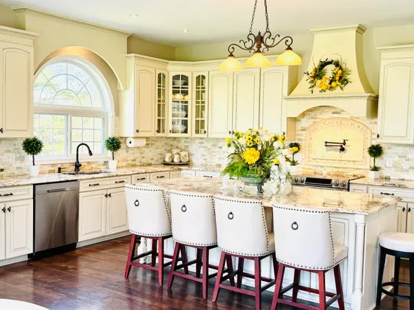 a view of a dining room with furniture a chandelier and wooden floor
