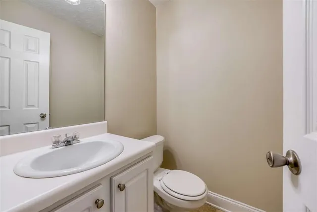 a kitchen with stainless steel appliances granite countertop a refrigerator stove top oven sink and cabinets