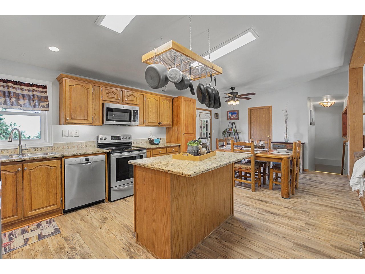8701 Rock Hill Road Loveland, CO 80537 - Photo 16 of 50 a kitchen with stainless steel appliances granite countertop a stove and a sink