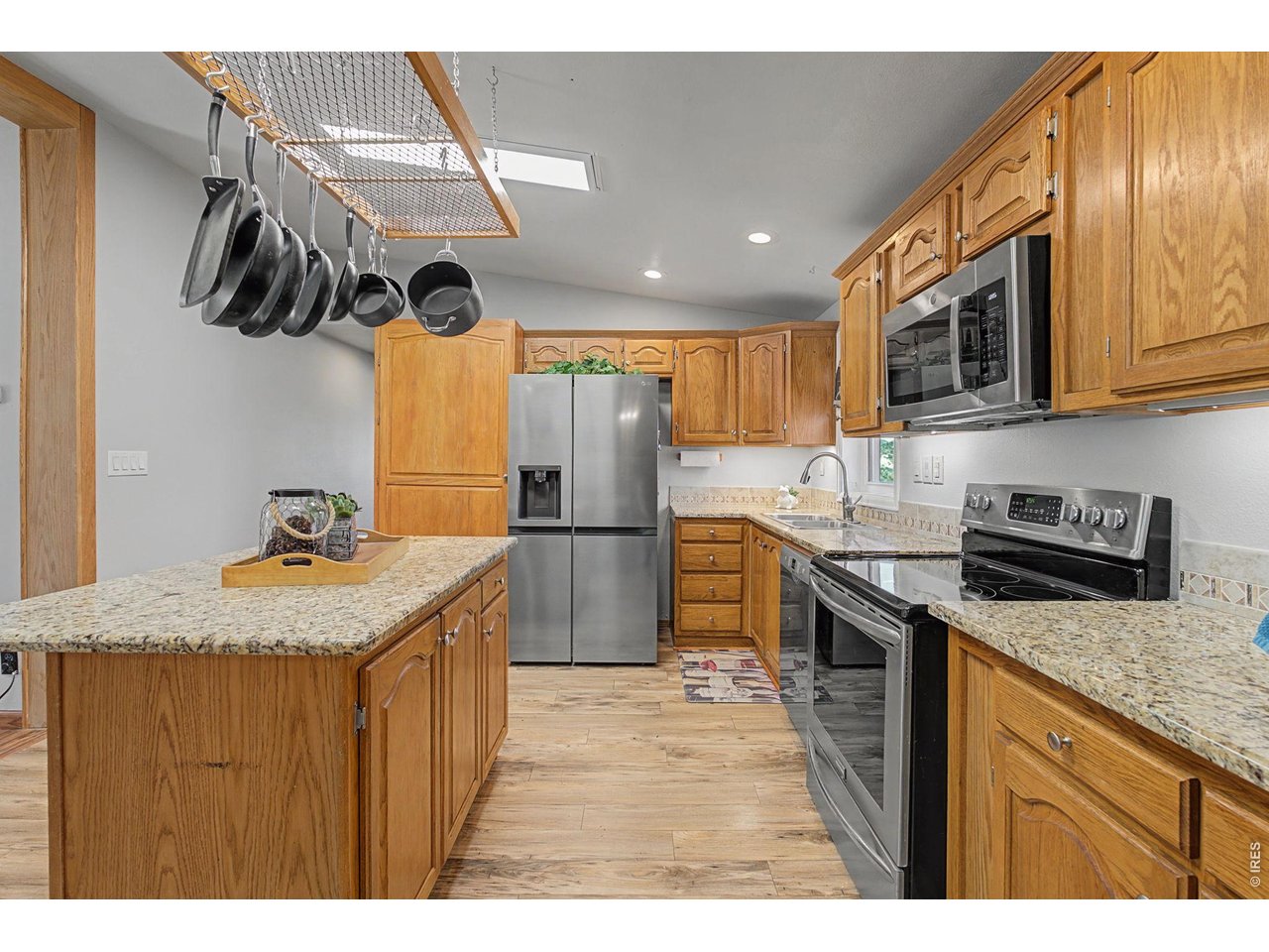 8701 Rock Hill Road Loveland, CO 80537 - Photo 18 of 50 a kitchen with stainless steel appliances granite countertop a sink a stove and a refrigerator