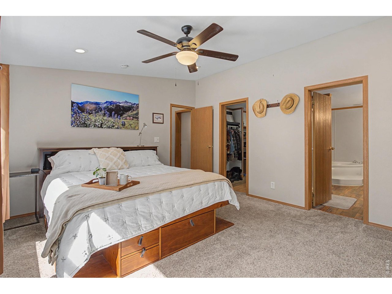 8701 Rock Hill Road Loveland, CO 80537 - Photo 21 of 50 a spacious bedroom with a bed and a ceiling fan