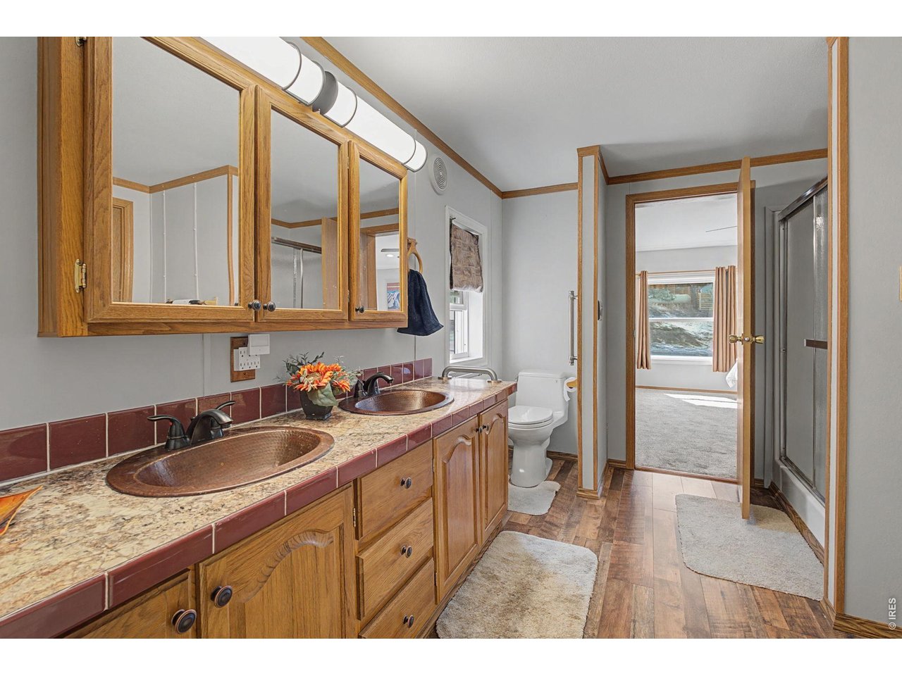 8701 Rock Hill Road Loveland, CO 80537 - Photo 22 of 50 a bathroom with a sink a vanity and a mirror