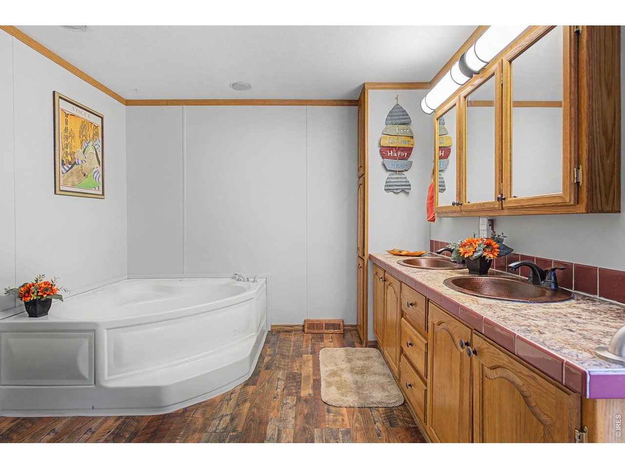 8701 Rock Hill Road Loveland, CO 80537 - Photo 23 of 50 a bathroom with a sink a mirror and a toilet