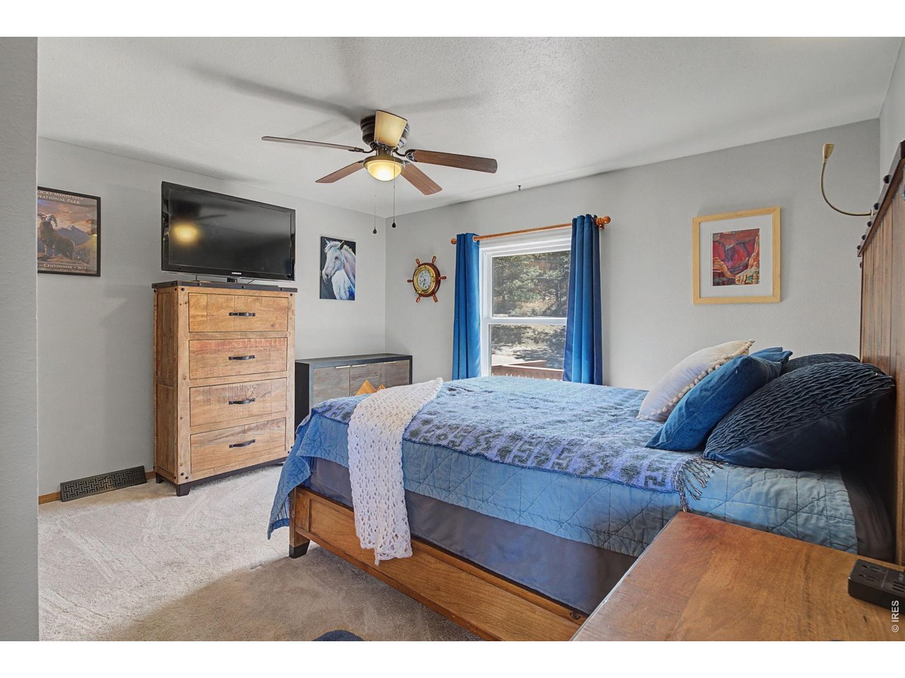 8701 Rock Hill Road Loveland, CO 80537 - Photo 26 of 50 a bedroom with a bed and a flat screen tv