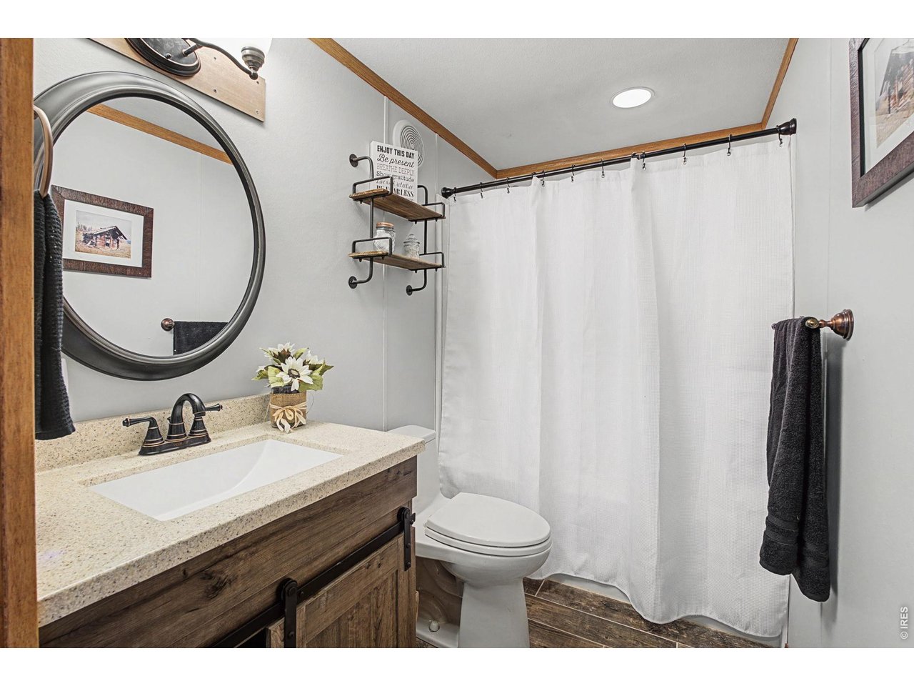 8701 Rock Hill Road Loveland, CO 80537 - Photo 34 of 50 a bathroom with a sink vanity mirror and toilet