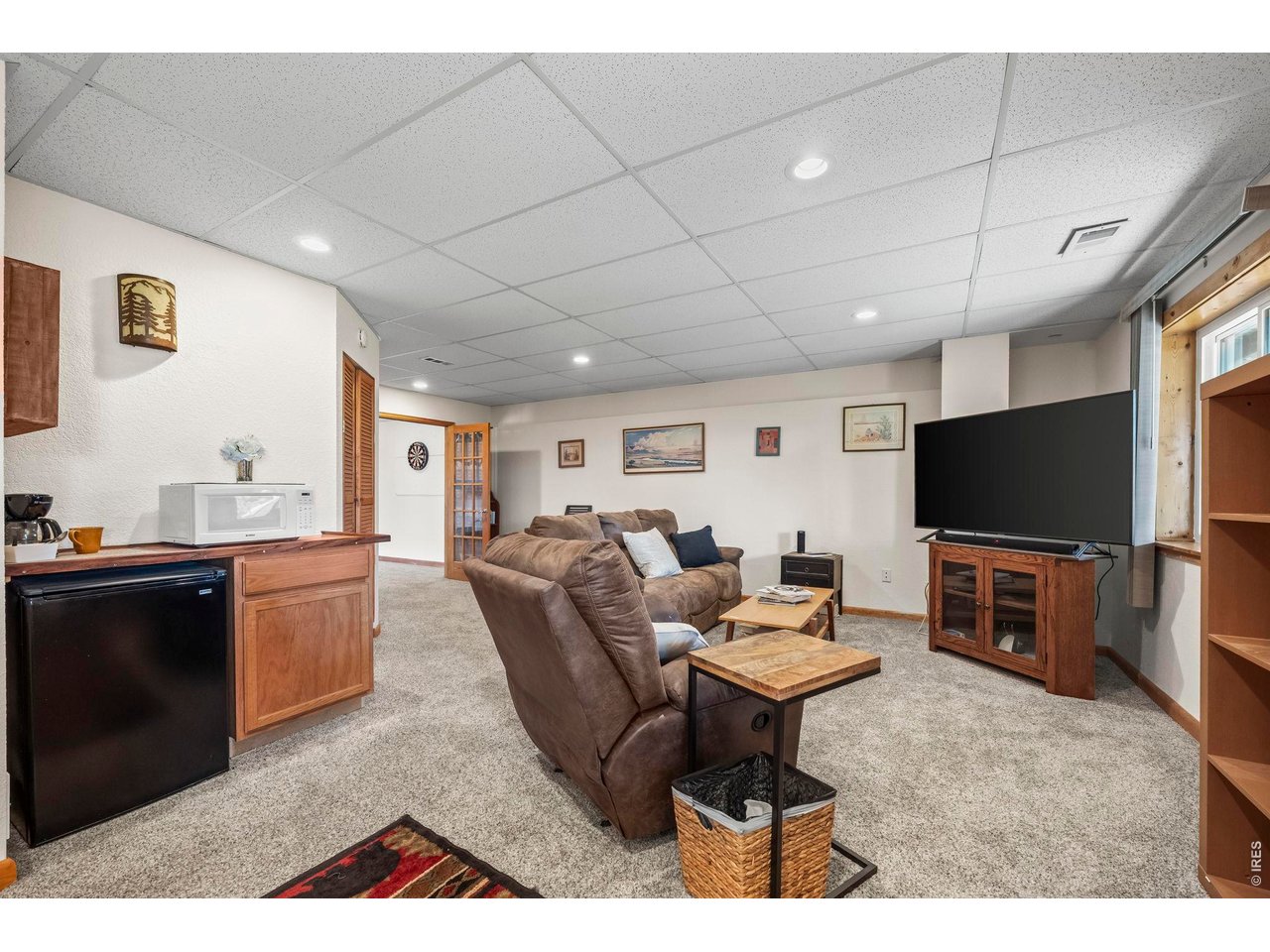 8701 Rock Hill Road Loveland, CO 80537 - Photo 42 of 50 a living room with furniture and a flat screen tv