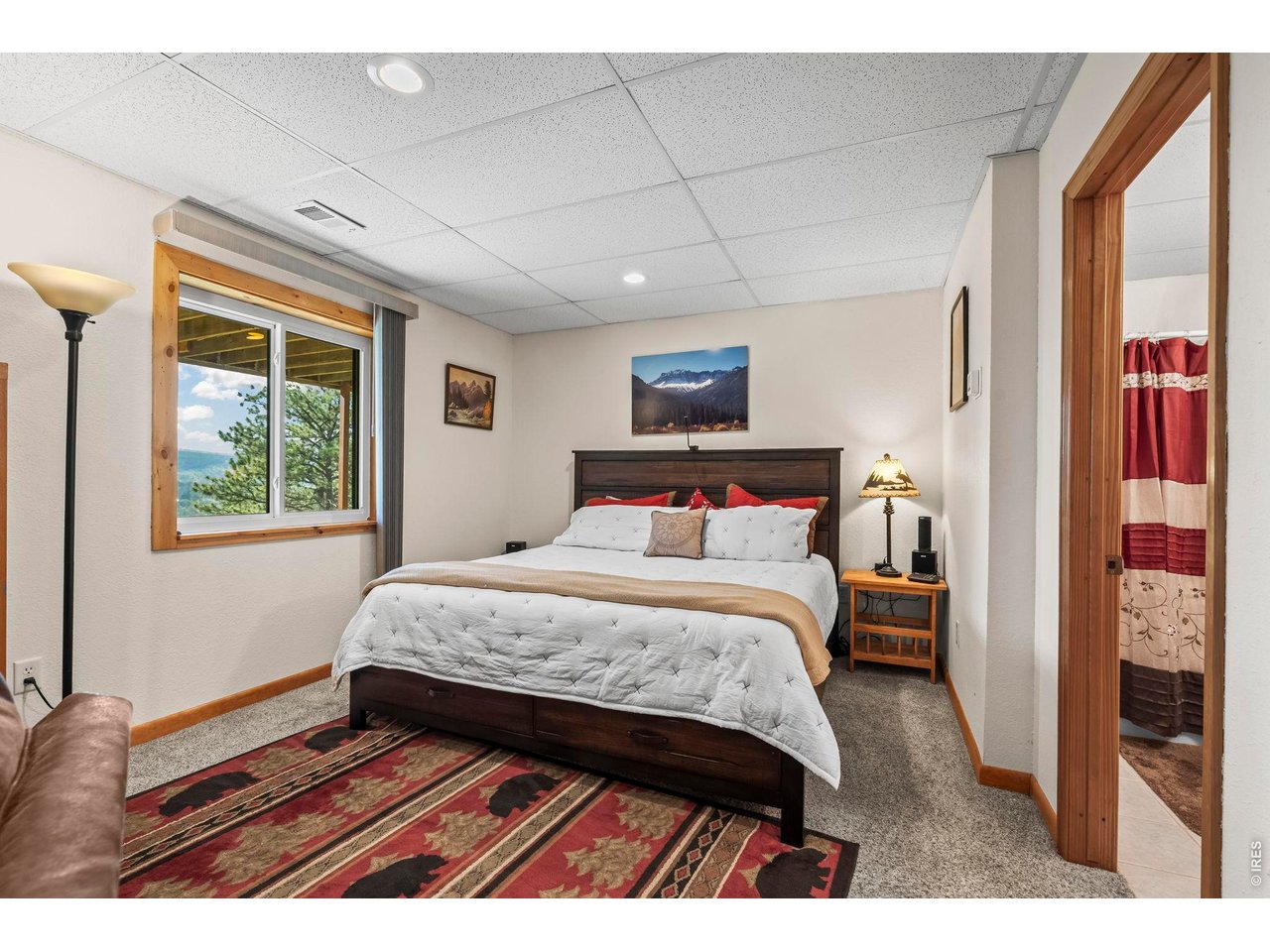 8701 Rock Hill Road Loveland, CO 80537 - Photo 43 of 50 a bedroom with a bed and a window