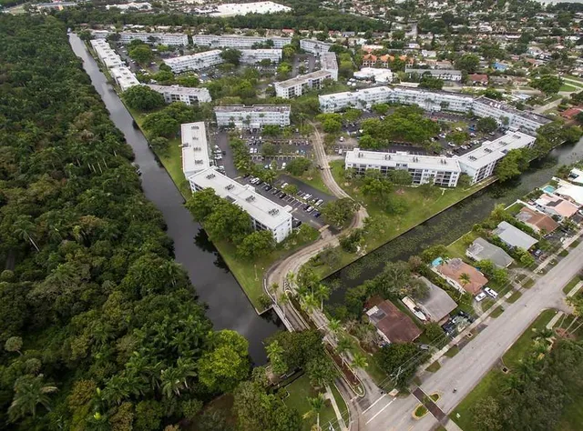 an aerial view of residential houses with outdoor space