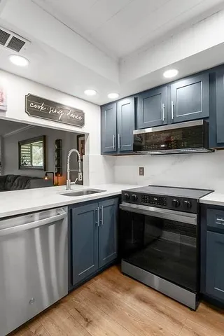 a kitchen with granite countertop a stove and a sink