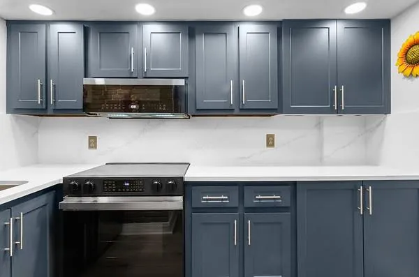 a kitchen with stainless steel appliances granite countertop a sink a stove and a microwave