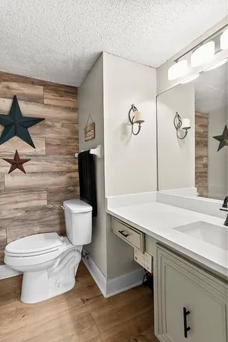 a bathroom with a toilet a sink and mirror