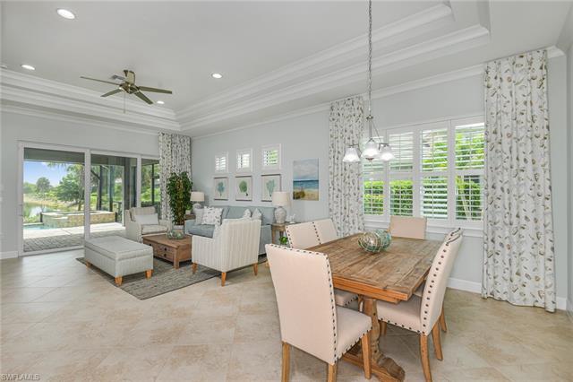 8777 Yucatan Court Naples, FL 34113 - Photo 11 of 41 a view of a dining room with furniture wooden floor and chandelier
