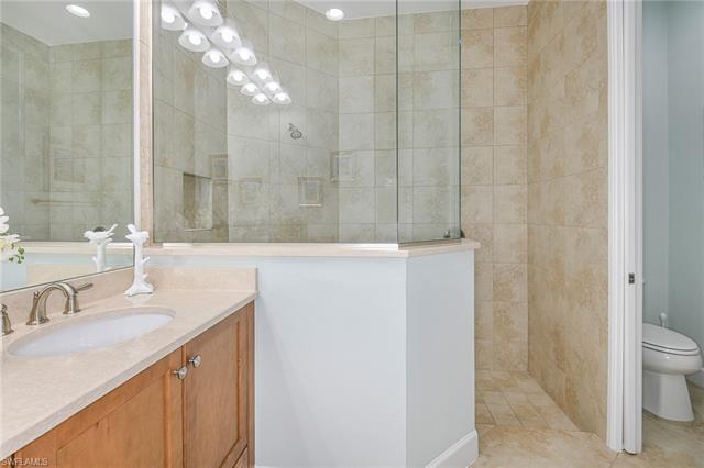 8777 Yucatan Court Naples, FL 34113 - Photo 16 of 41 a bathroom with a sink vanity granite and a toilet