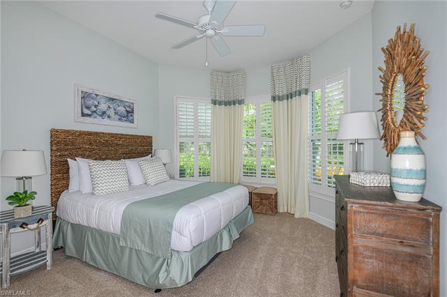 8777 Yucatan Court Naples, FL 34113 - Photo 18 of 41 a bedroom with a large bed and a window
