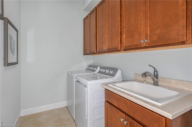 8777 Yucatan Court Naples, FL 34113 - Photo 25 of 41 a utility room with sink dryer and washer