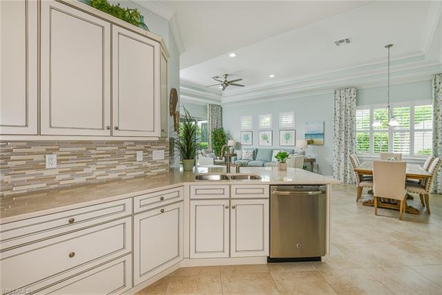 8777 Yucatan Court Naples, FL 34113 - Photo 5 of 41 a kitchen with white cabinets and sink