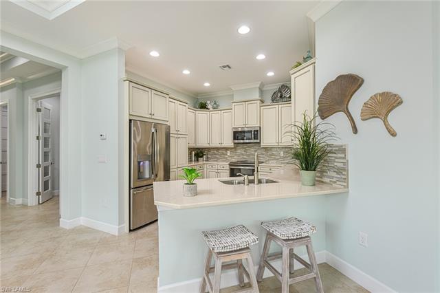 8777 Yucatan Court Naples, FL 34113 - Photo 7 of 41 a kitchen with kitchen island cabinets and refrigerator