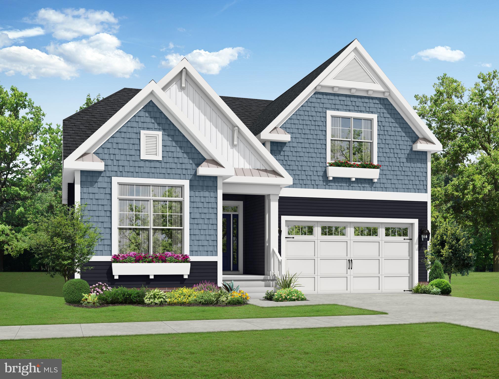 19497 Safflower Way Lewes, DE 19958 - Photo 3 of 4 a front view of a house with a garden and yard