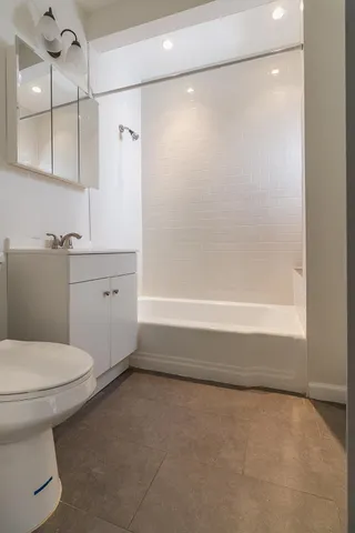 a bathroom with a toilet and a bathtub