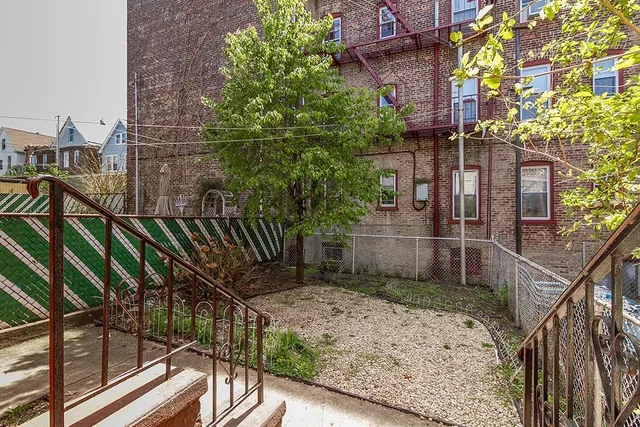 a backyard of a building with glass door and glass windows