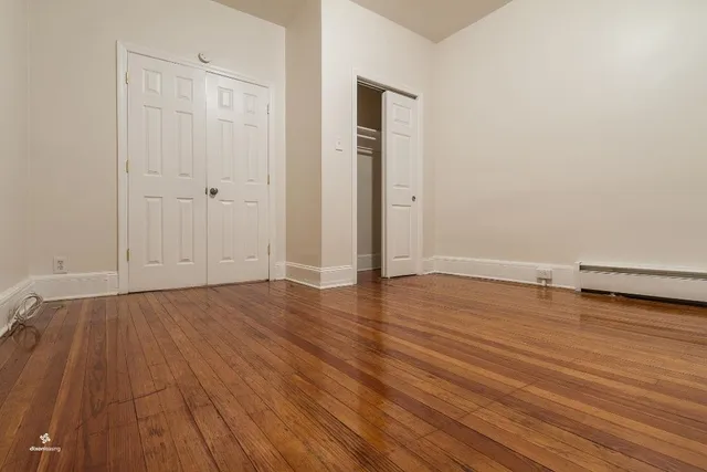 an empty room with wooden floor