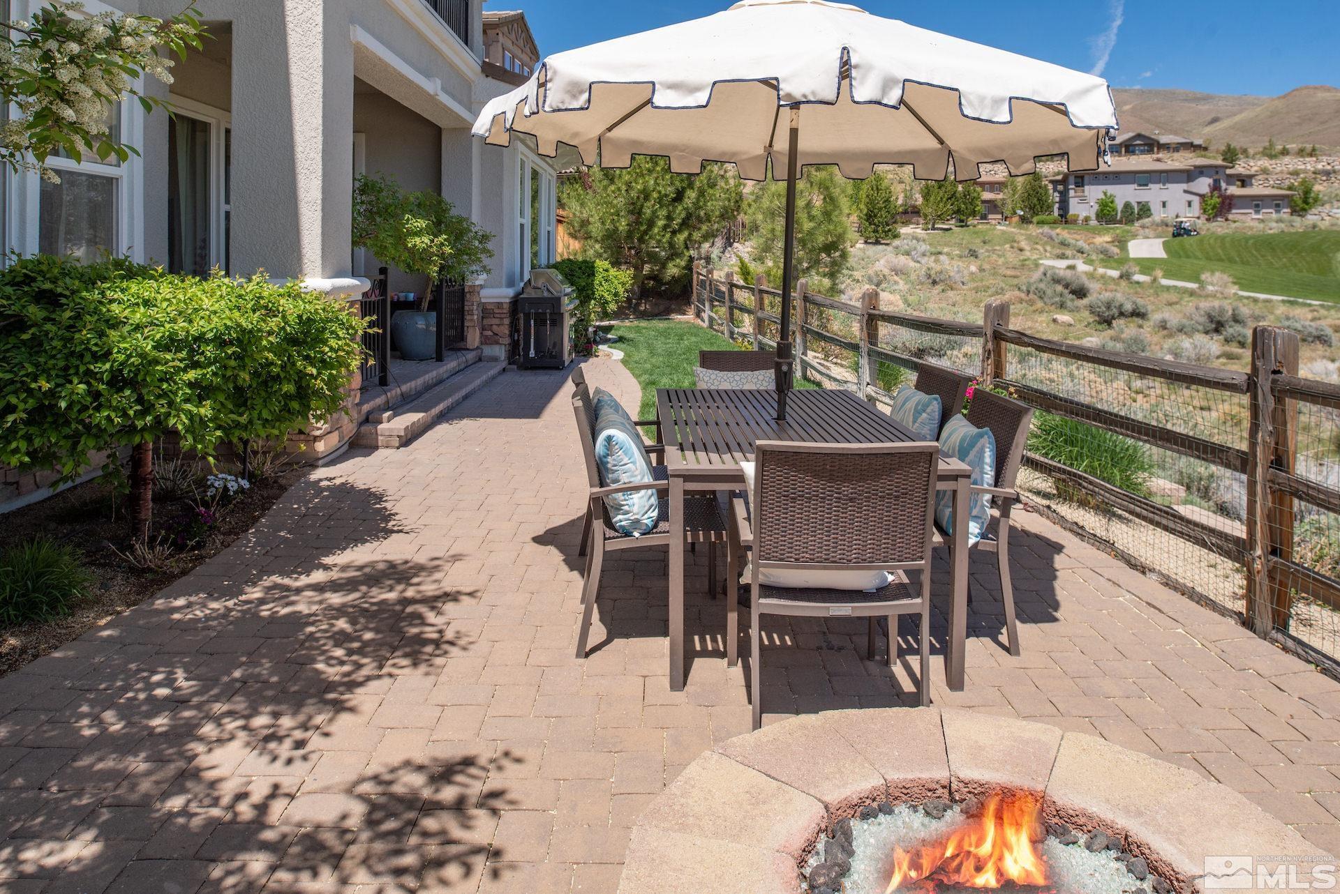 1772 Fairway Hills Trail Reno, NV 89523 - Photo 32 of 33 a view of a patio with a table and chairs under an umbrella