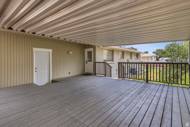 2693 Teal Way Sandy, UT 84093 - Photo 39 of 50 Spacious covered deck featuring wood-finish flooring, a full ceiling, and dark-stained railings