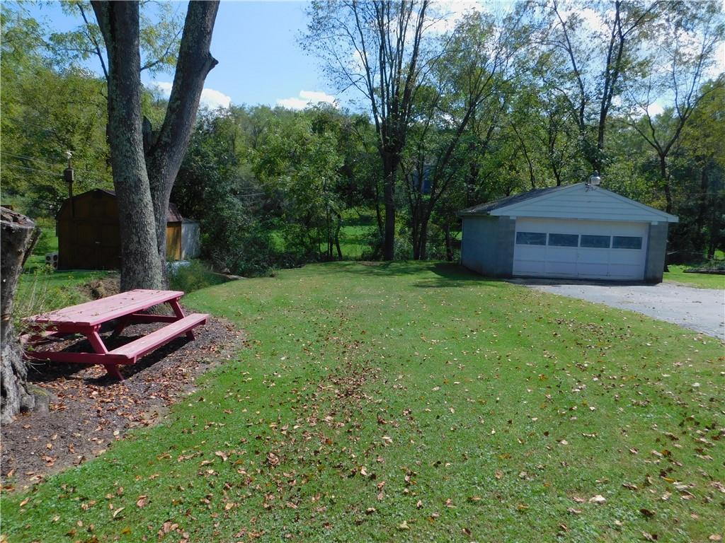 476 Ross Road Eighty Four, PA 15330 - Photo 18 of 20 a view of a backyard with a garden and trees