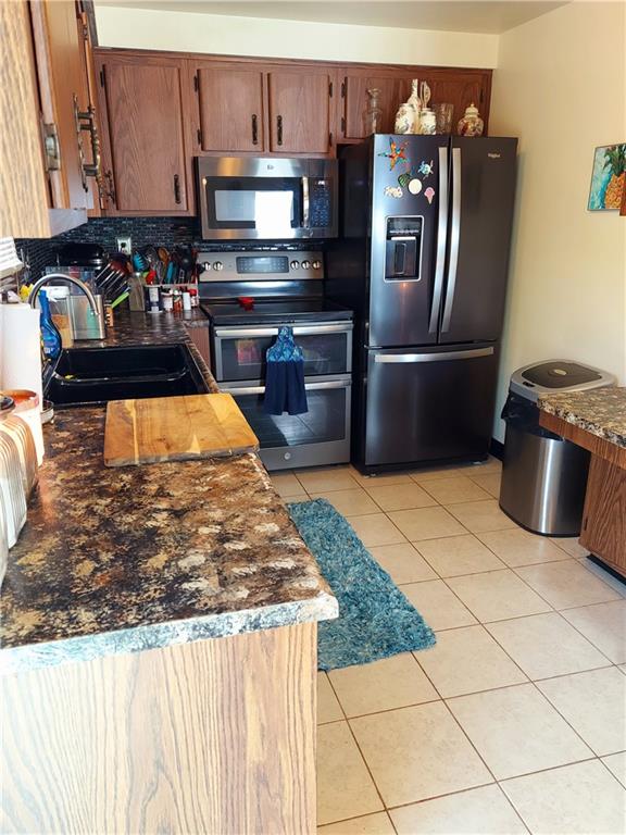 476 Ross Road Eighty Four, PA 15330 - Photo 9 of 20 a kitchen with stainless steel appliances granite countertop a refrigerator a stove and a sink