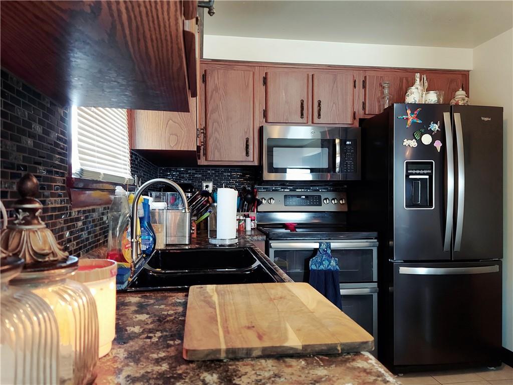 476 Ross Road Eighty Four, PA 15330 - Photo 10 of 20 a kitchen with stainless steel appliances a refrigerator a stove a sink and a cabinets