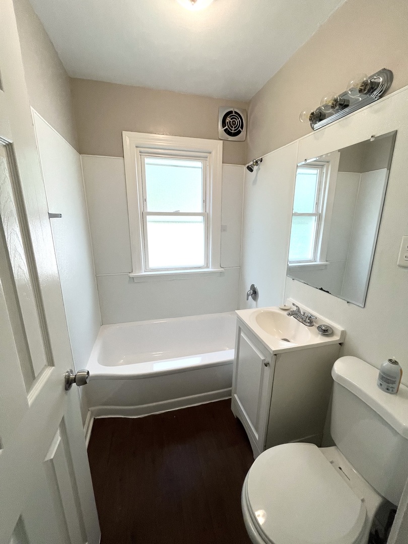 21142 Locust Street Matteson, IL 60443 - Photo 16 of 16 a bathroom with a sink toilet vanity and bathtub